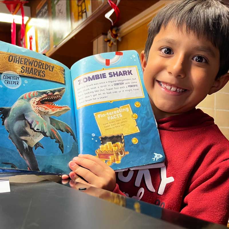 Boy showing off his book